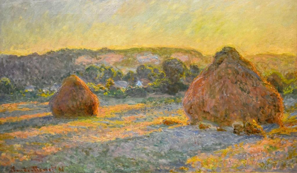 Claude Monet Stacks of Wheat at the end of summer in warm low-angle light.